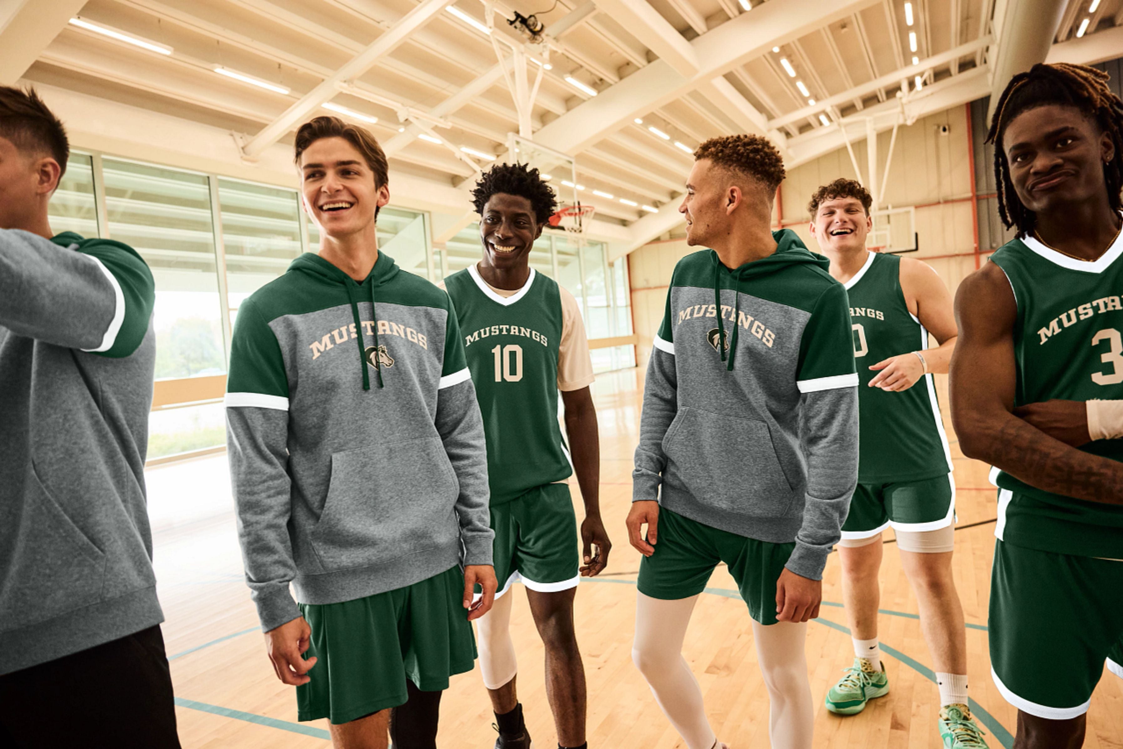 A basketball team wearing green jerseys in the gym